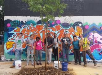 youth crew standing around a tree they just planted