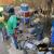 Youth learning about installing rain barrels.