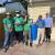 Youth smiling after installing a rain barrel.