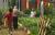 Three people standing and walking around the community garden